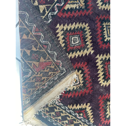 Antique 1900s tribal Baluch wool rug in dark purple with geometric patterns