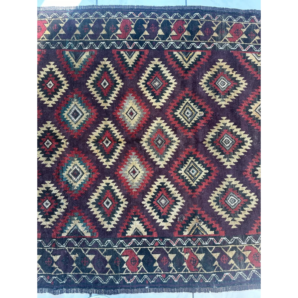 Antique 1900s tribal Baluch wool rug with dark purple geometric patterns