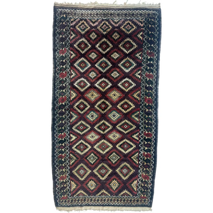 Antique 1900s Tribal Baluch wool rug with dark red cream geometric diamond motifs
