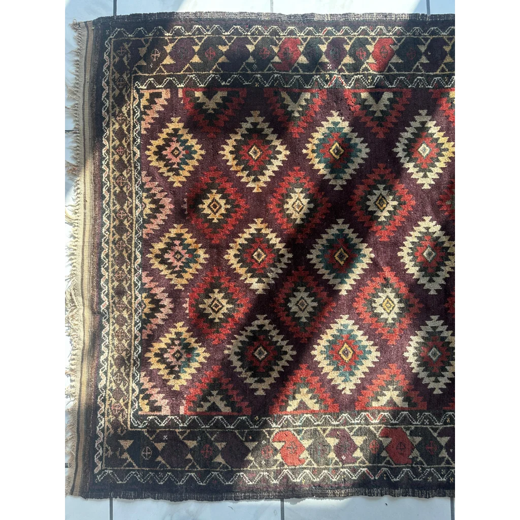 Antique 1900s tribal Baluch wool rug with dark red cream geometric patterns