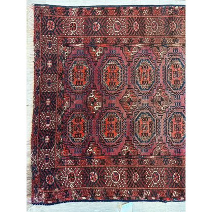 Antique 1910s Turkoman rug with geometric angular motifs in deep red, blue and cream natural wool