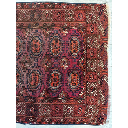 Antique 1910s tribal Turkoman rug in deep red burgundy with angular geometric wool pile designs