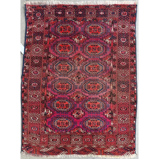 Antique 1910s Tribal Turkoman rug in red, purple, blue, cream geometric patterns