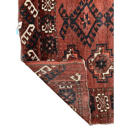Antique Kizil Ayak Turkoman chuval rug with rust-red base and geometric patterns
