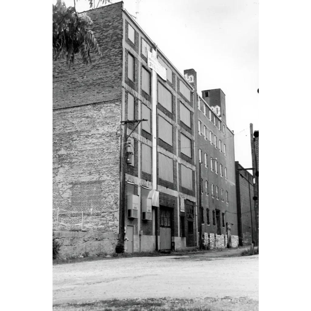 Vintage orphan boy smoking tobacco label on brick St. Louis building