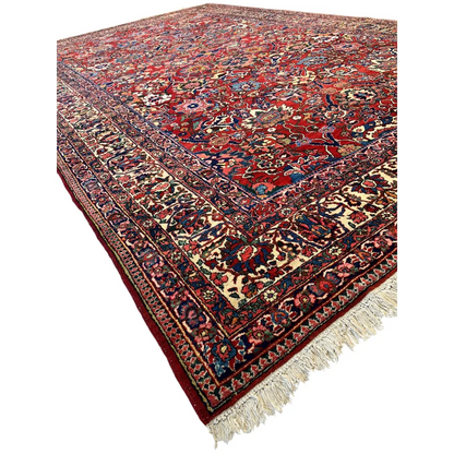 Rich Persian Bakhtiari rug with floral patterns in red, navy, gold