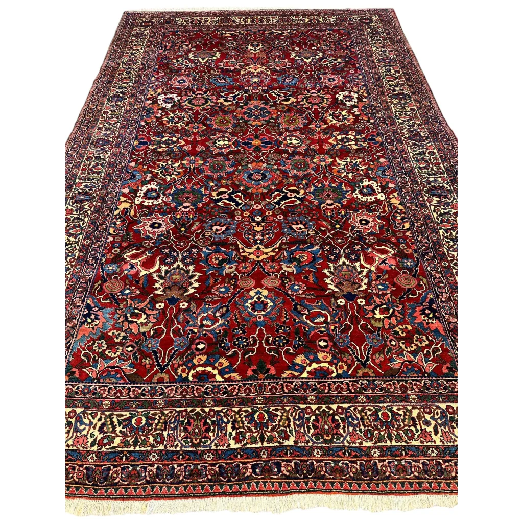 Antique Persian Bakhtiari rug in burgundy red with floral patterns and central medallion