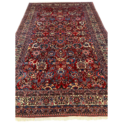 Antique Persian Bakhtiari rug in burgundy red with floral patterns and central medallion