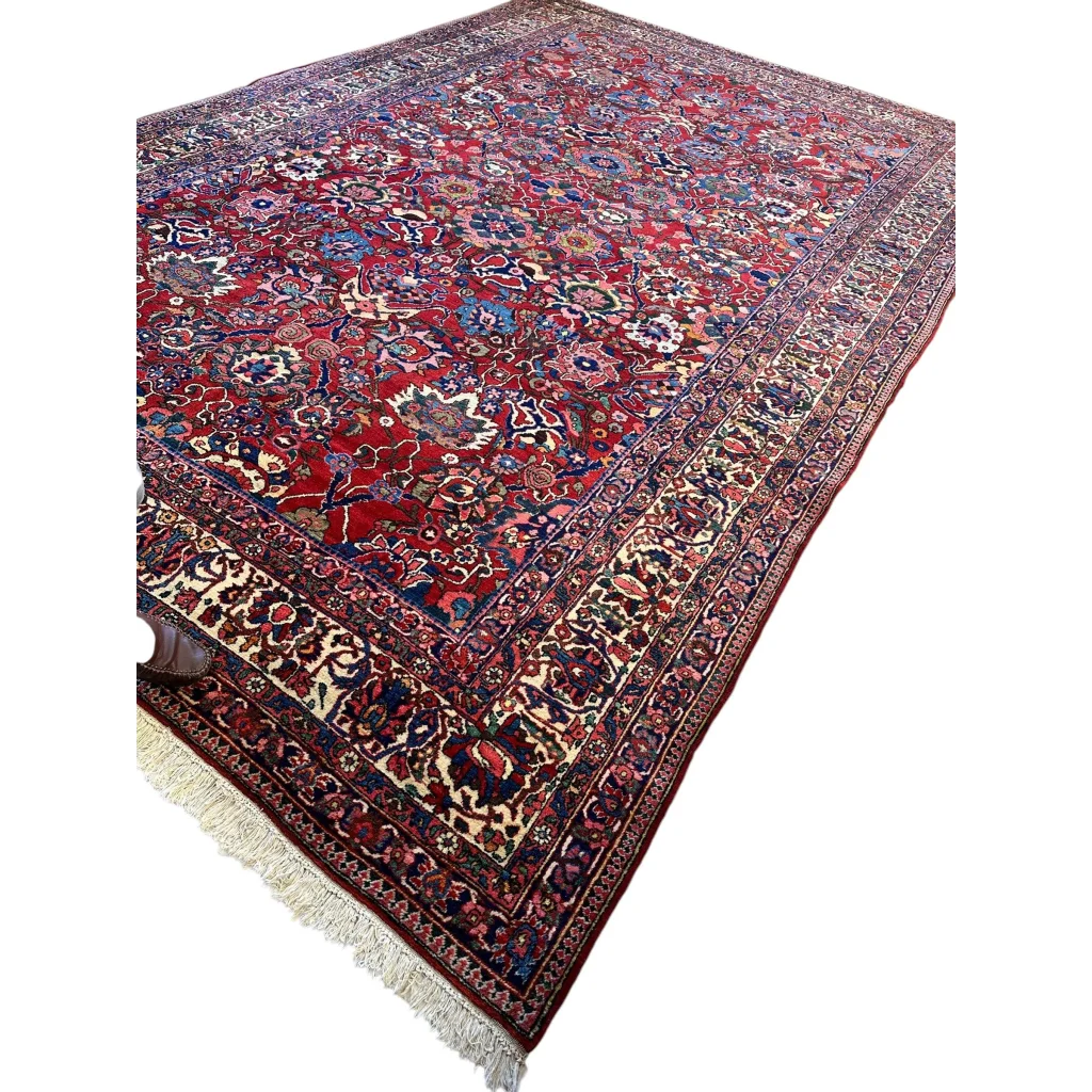 Antique Persian Bakhtiari rug with red floral patterns and fringe