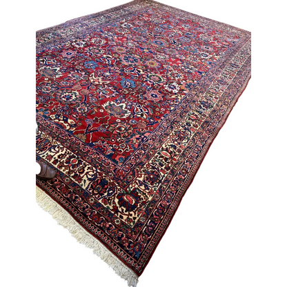 Antique Persian Bakhtiari rug with red floral patterns and fringe