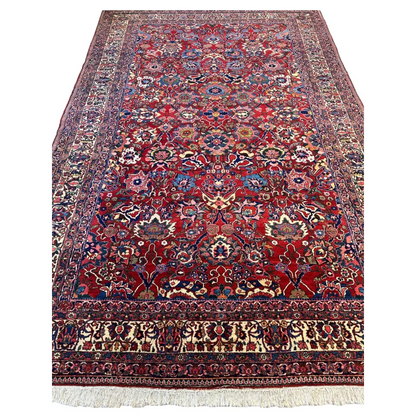 Antique Persian Bakhtiari rug with intricate floral vine details in red field