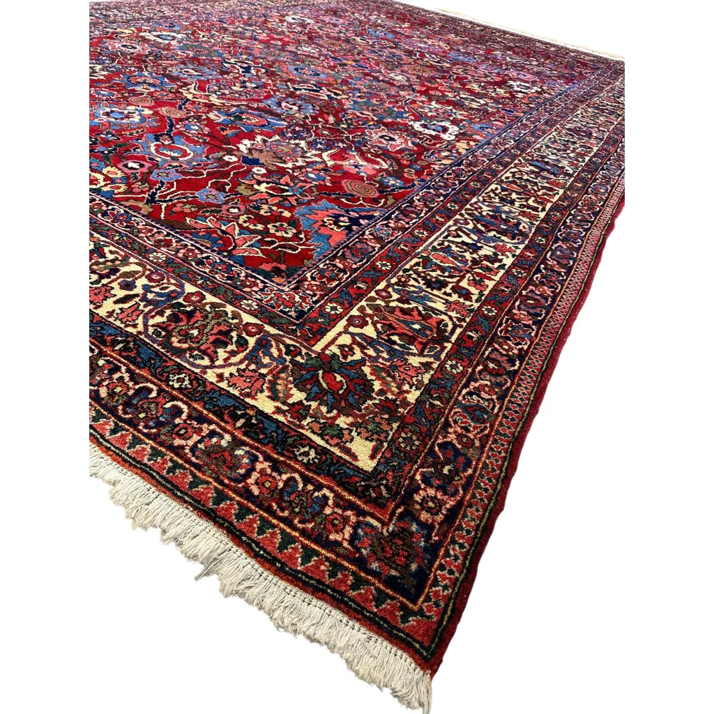 Antique Persian Bakhtiari rug with red floral patterns and fringe detail