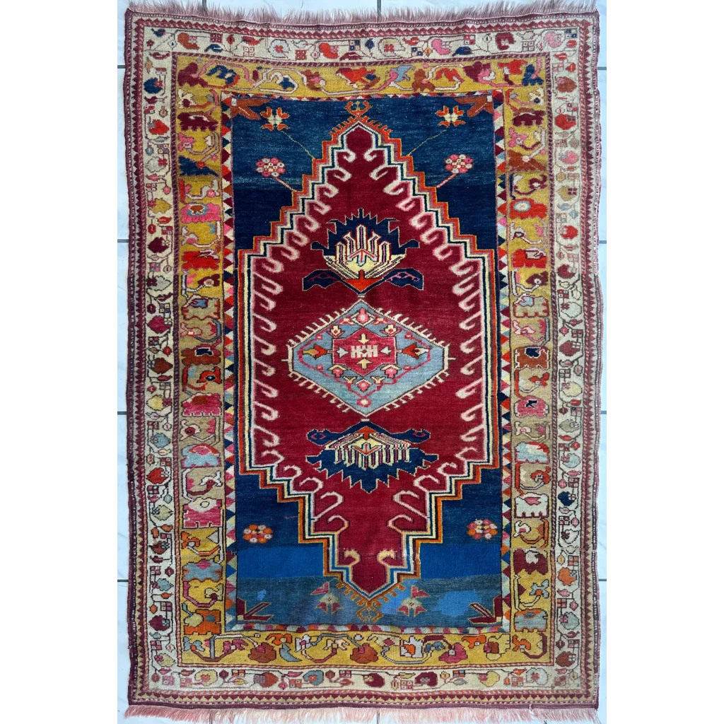 Vibrant antique Turkish Melas rug with red navy medallion and geometric motifs