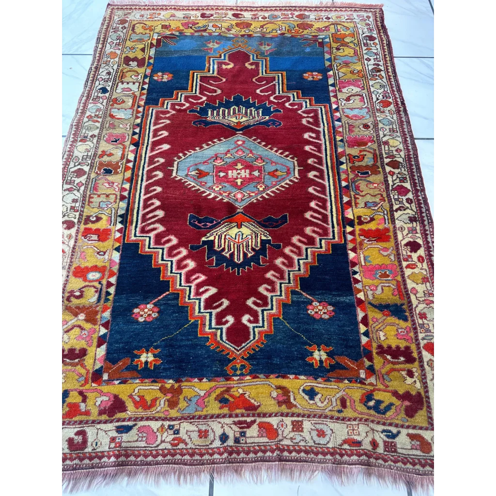Vibrant antique Turkish Melas rug with deep blue field and geometric motifs