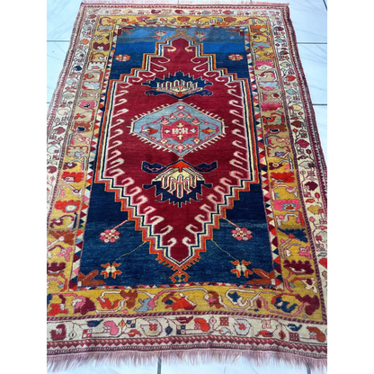 Vibrant antique Turkish Melas rug with deep blue field and geometric motifs