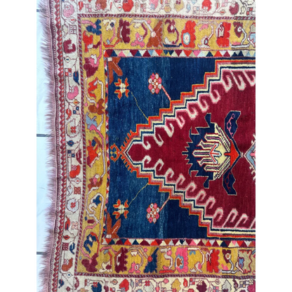 Vibrant antique Turkish Melas rug with geometric and floral patterns