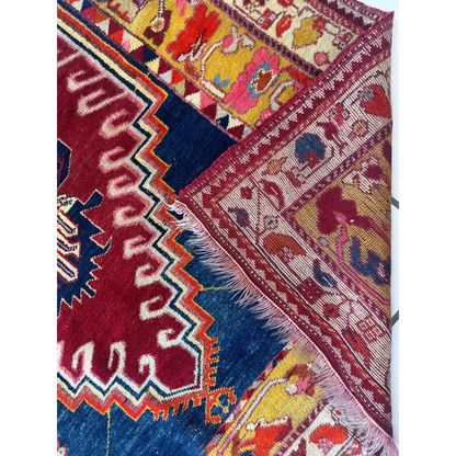Vibrant antique Turkish Melas rug with geometric floral patterns