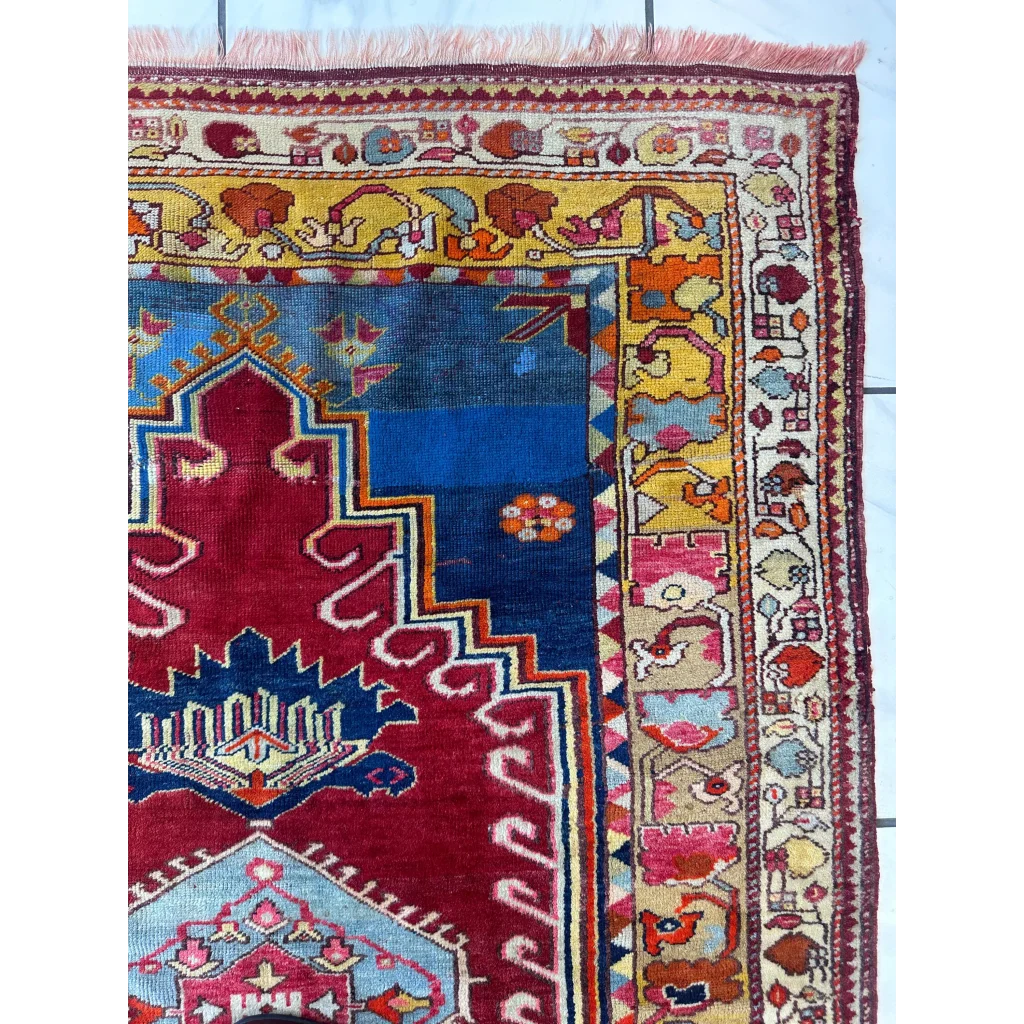 Vibrant antique Turkish Melas rug with geometric floral patterns