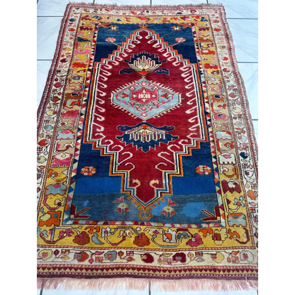 Vibrant antique Turkish Melas rug with geometric patterns and ornate borders