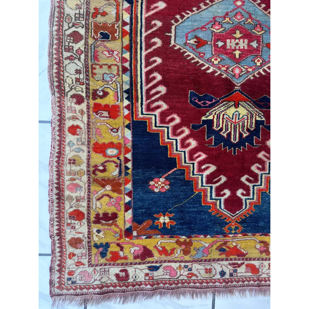 Vibrant antique Turkish Melas rug with intricate geometric and floral patterns