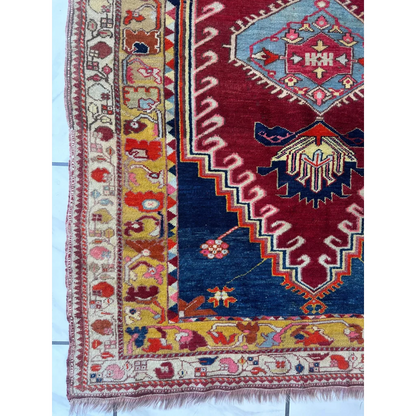 Vibrant antique Turkish Melas rug with intricate geometric and floral patterns