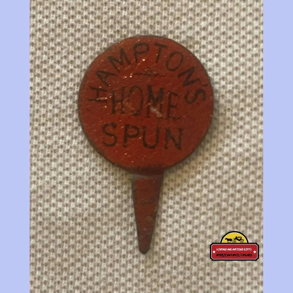 Circular red metal plant marker with LANGTONS HOME SPUN embossed text and pointed stake for tin tobacco tag collectors