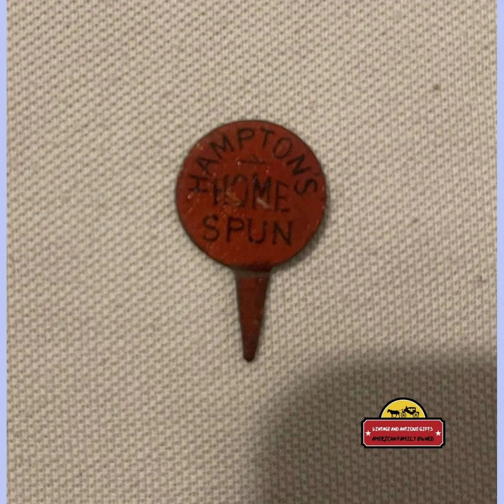 Circular red wooden tobacco tag with CRAFTON’S HOME SPUN on a pointed stake