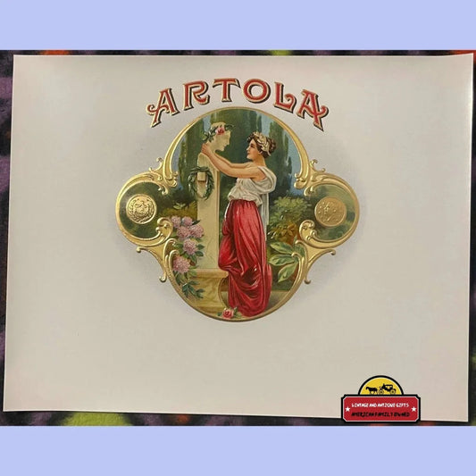 Vintage Artola Cigar Label showcasing a classy woman in an enchanting garden scene