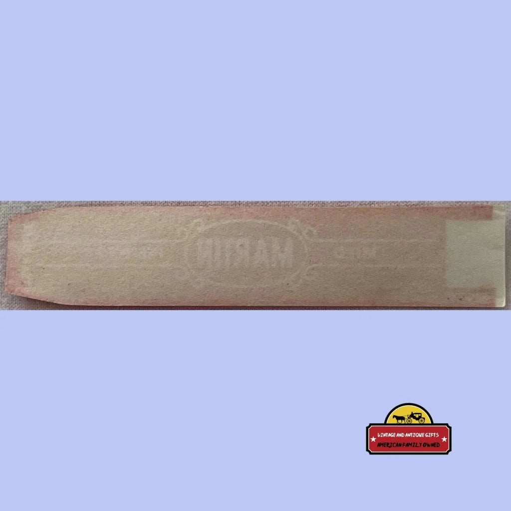 Wooden plank showing faded text with a Rare Martin Cigar Band design in burgundy