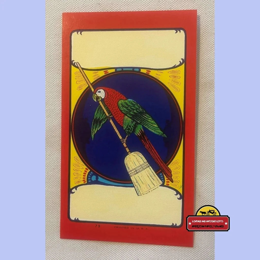 Colorful illustration of a parrot on a broom label against blue background