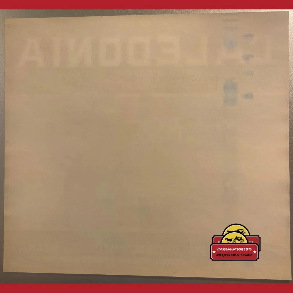 Beige bulletin board with a Caledonia Crate Label and a small red and yellow logo