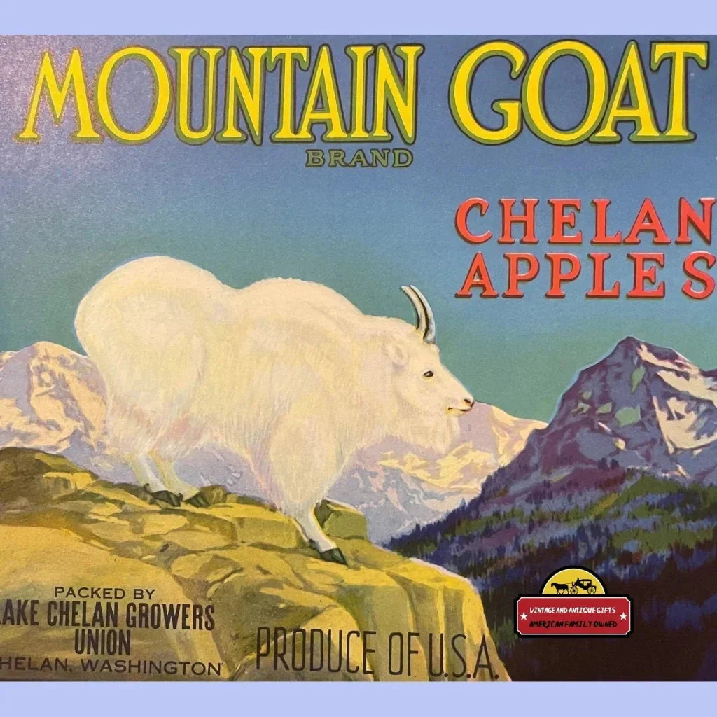 White Mountain Goat on rocky slope with snowy peaks, featured in antique crate label