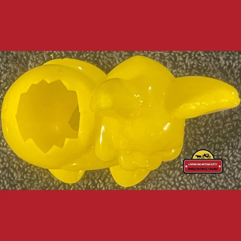 Yellow plastic dinosaur toy with hollow body, perfect for rabbit candy holder fun