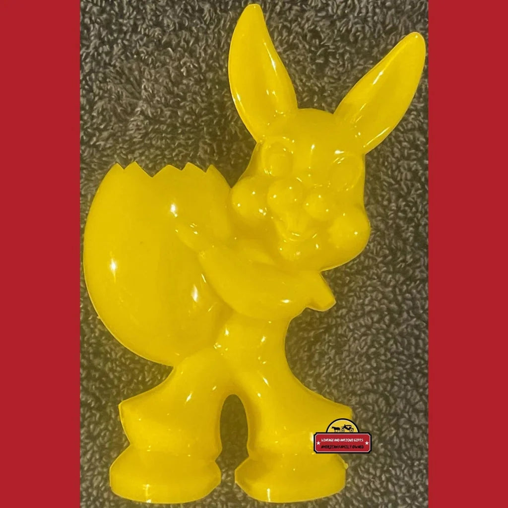 Bright yellow rabbit candy holder figurine with an egg, perfect for Easter joy