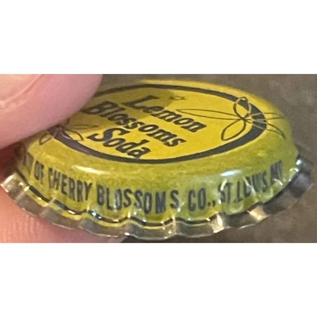 Vintage 1950s Lemon Blossom Soda cork bottle cap shown in Antique product display