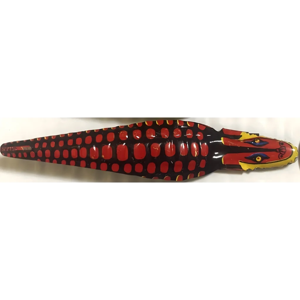 Wooden crocodile figurine in red and black with yellow accents, perfect for vintage 1950s decor