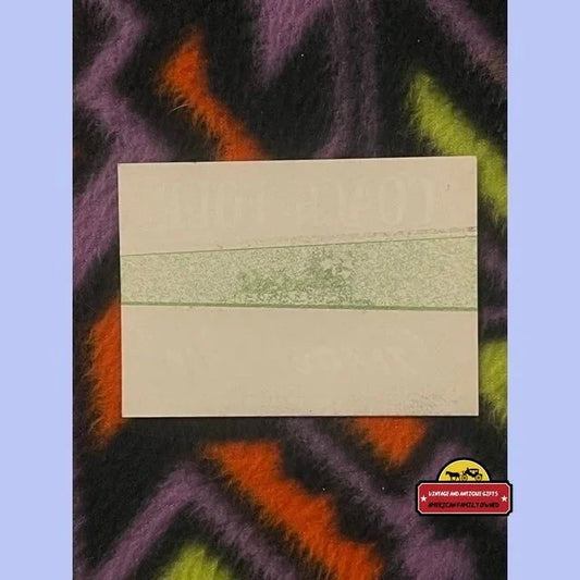Faded green vintage ginger ale label with horizontal stripe, white background.