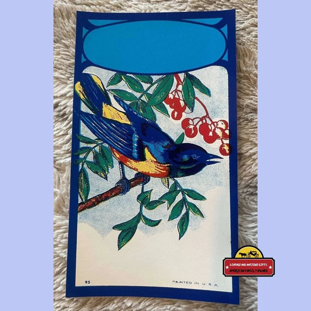 Colorful bluebird broom label featuring a bird on a branch with berries and leaves