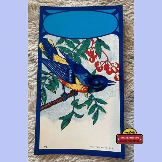 Colorful bluebird broom label featuring a bird on a branch with berries and leaves