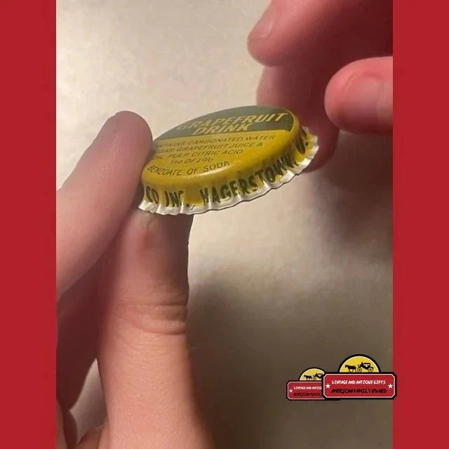 Vintage Grapefruit bottle cap from the 1960s held between fingers for display