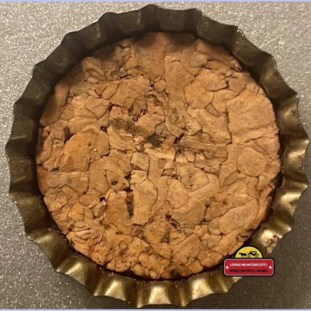 Baked cookie in a fluted pan next to an Antique Vintage Lime Cola Bottle Cap