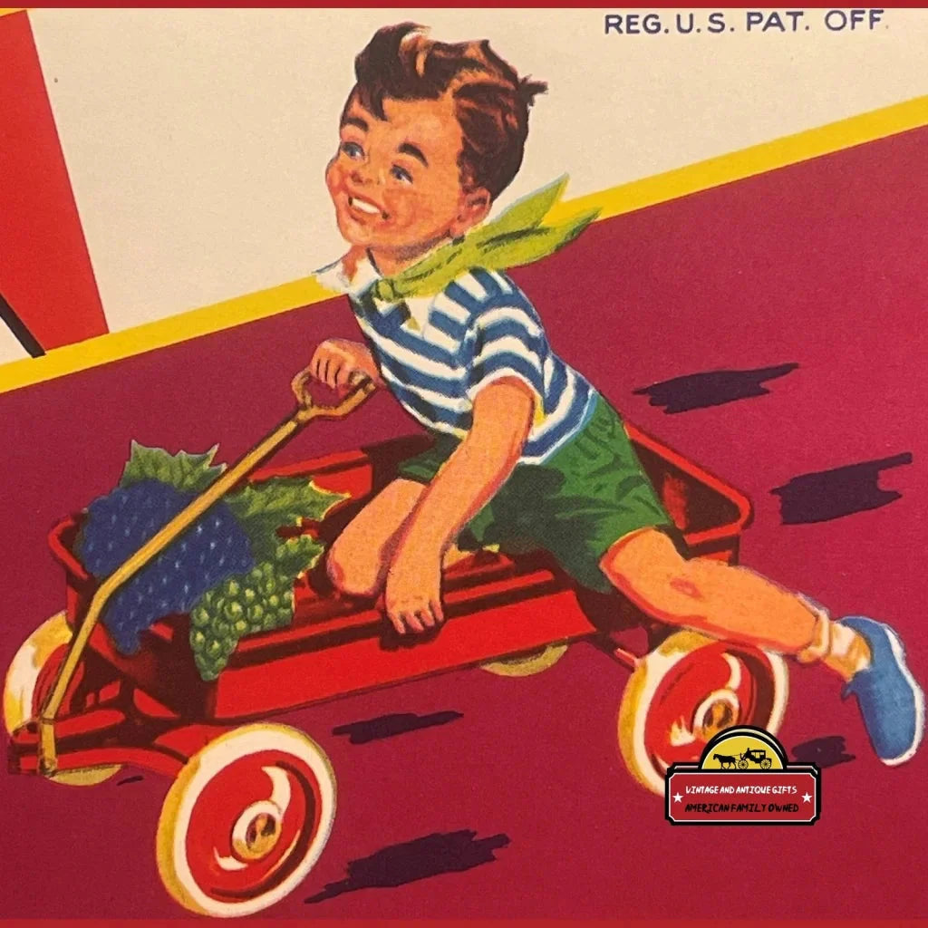 Smiling boy in a red wagon filled with grapes on a Rare 1950s Antique Vintage Crate Label