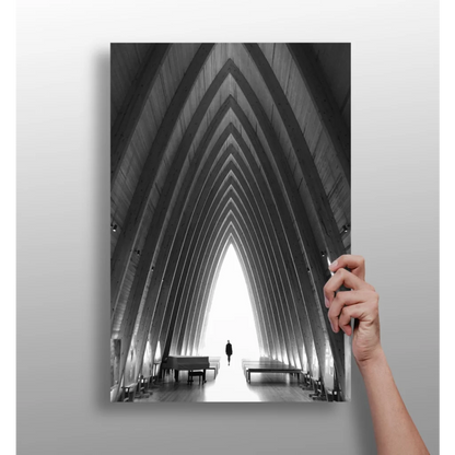 Black-and-white photo of person in arched corridor with distant piano on aluminum print