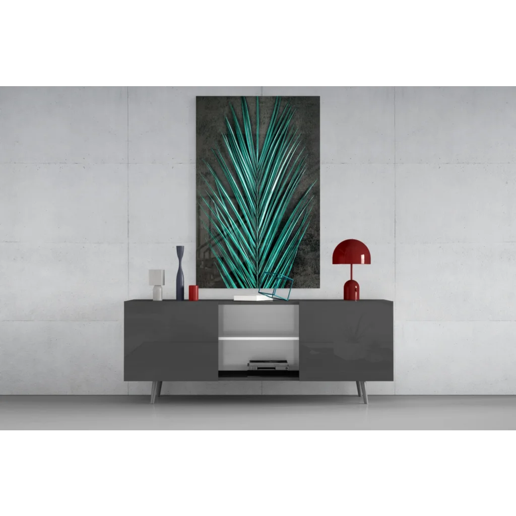 Vibrant teal palm leaf glass wall art with metallic sheen on gray console