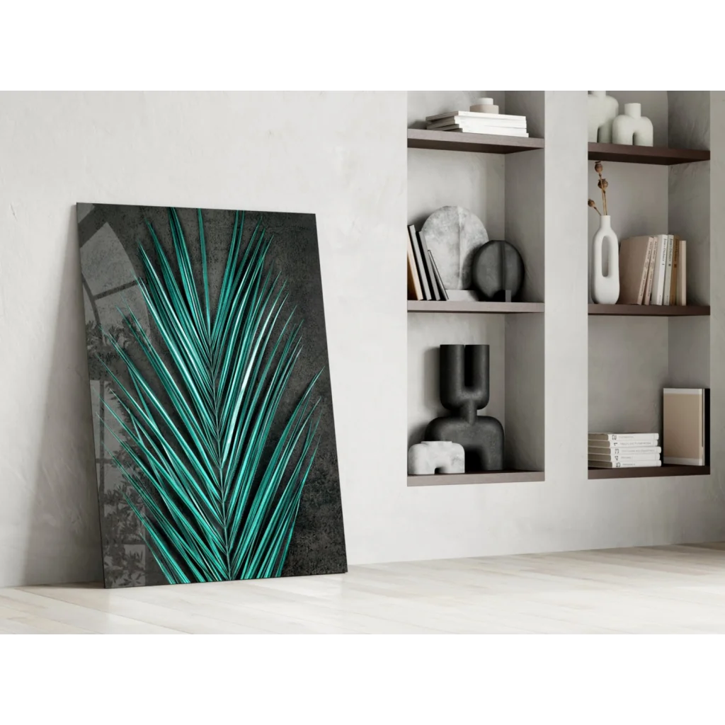 Vibrant teal palm leaf glass wall art leaning on white wall