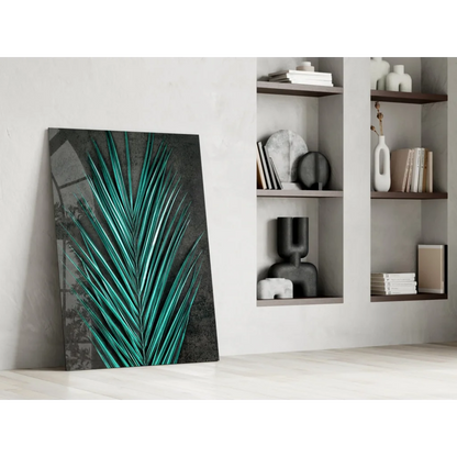 Vibrant teal palm leaf glass wall art leaning on white wall
