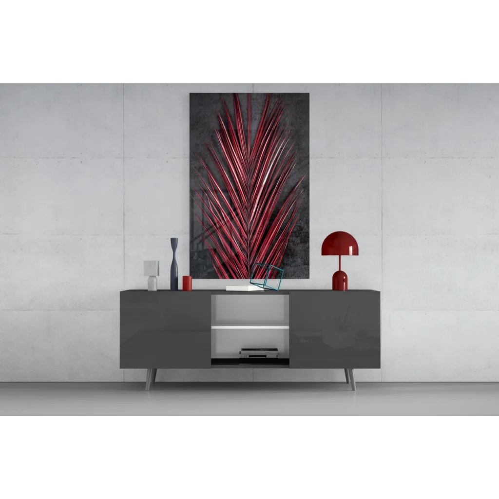 Vibrant red metallic palm leaf glass wall art on dark gray wall