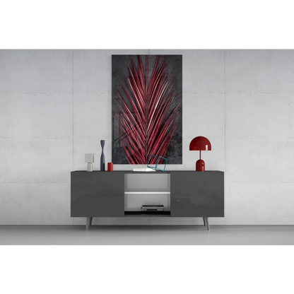 Vibrant red metallic palm leaf glass wall art on dark gray wall