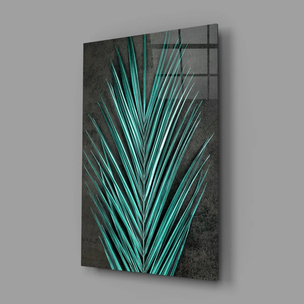 Vibrant teal palm leaf glass wall art on textured dark gray background