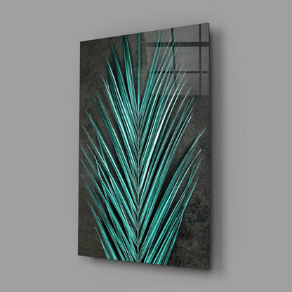 Vibrant teal palm leaf glass wall art on textured dark gray background